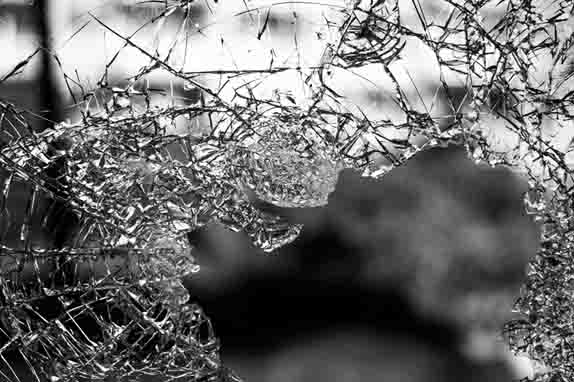 Zoomed black and white image of a broken glass